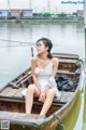 A woman sitting in a boat on the water.