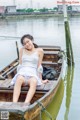 A woman sitting in a boat on the water.