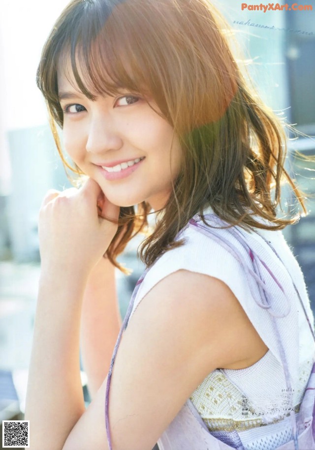 A young woman with long brown hair posing for a magazine.