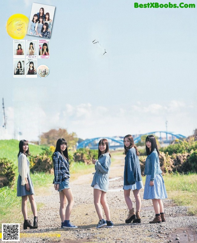 A group of young women standing next to each other on a dirt road.